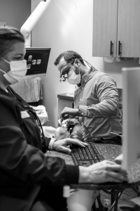Dentist performing teeth cleaning treatment
